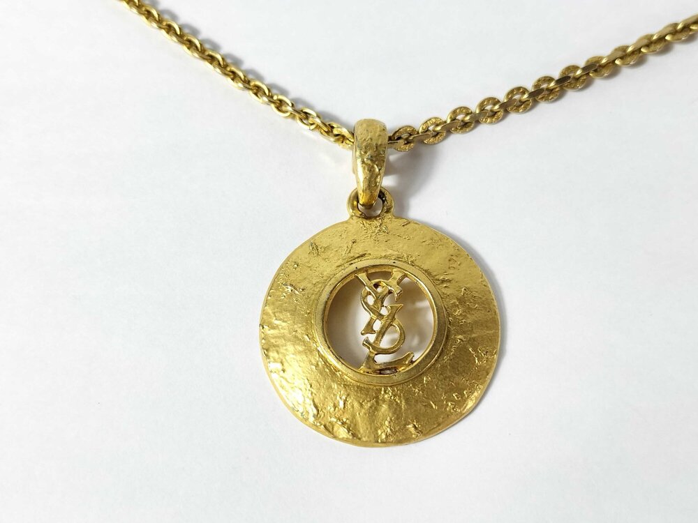 Vintage Yves Saint Laurent Gold Tone Hammered Round Cutout YSL Logo Pendant Neck
